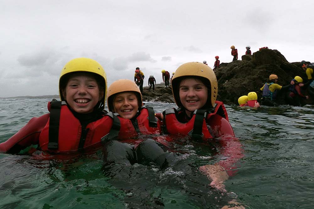 Clore Duffield Coasteering A trio of students in the water at Newquay