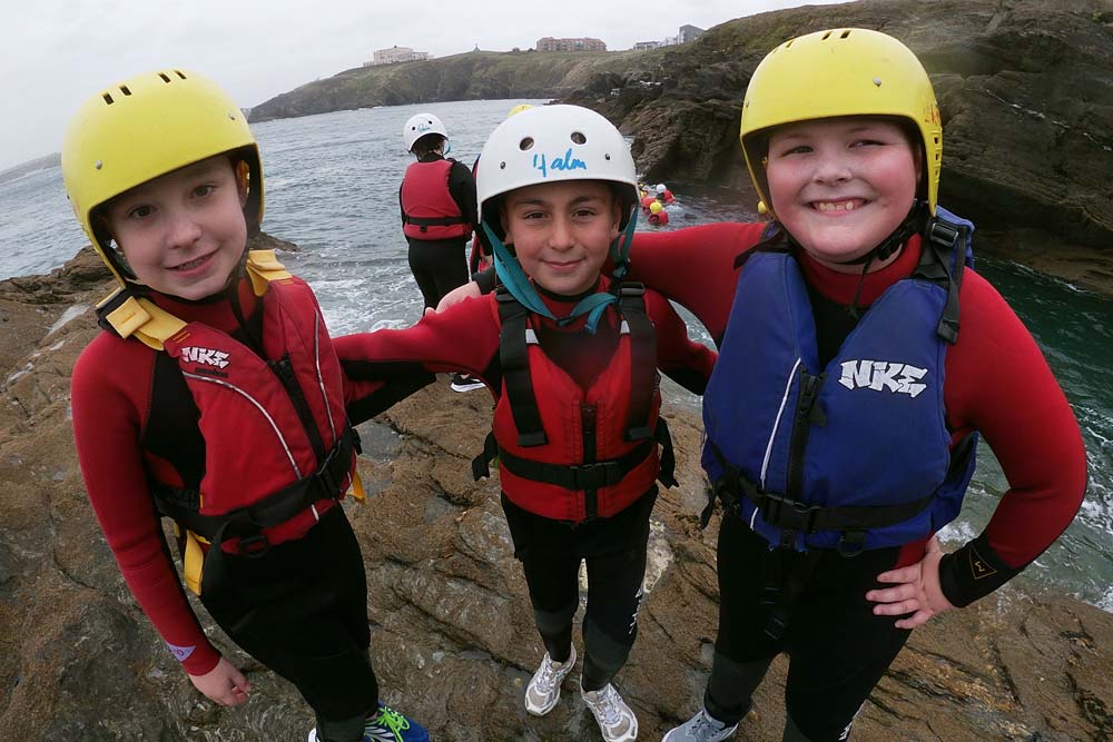 Clore Duffield Coasteering A trio of students on the cliffs at Newquay